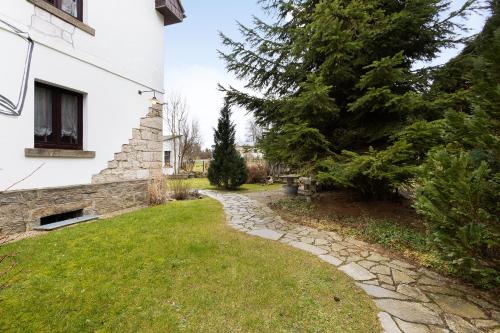 a garden with a stone path next to a house at Buchhaus Vier - Erdgeschoss in Kirchenlamitz