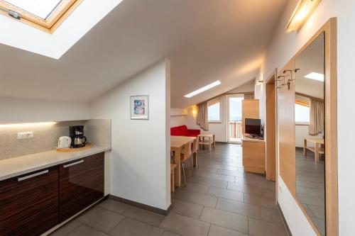 a kitchen and living room with a dining room at Der Blaue Reiter in Schenna