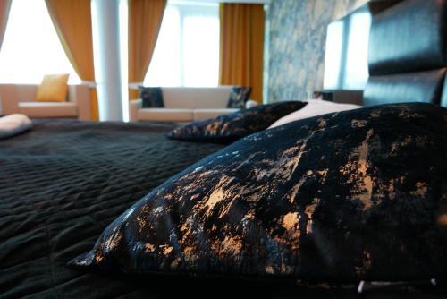 a bedroom with a bed with two pillows on it at Hotel Oskar Business & Spa in Puławy