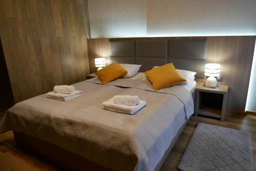 a bedroom with a large bed with towels on it at Hotel Oskar Business & Spa in Puławy