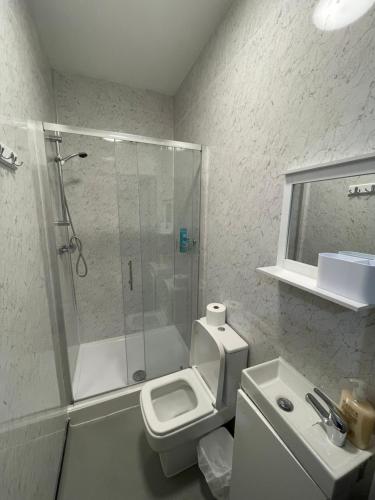 a bathroom with a shower and a toilet and a sink at Luxurious En-suite Room 5 in Manchester