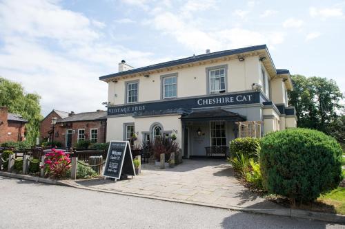 a white building with a sign in front of it at The Cheshire Cat by Innkeeper's Collection in Chester
