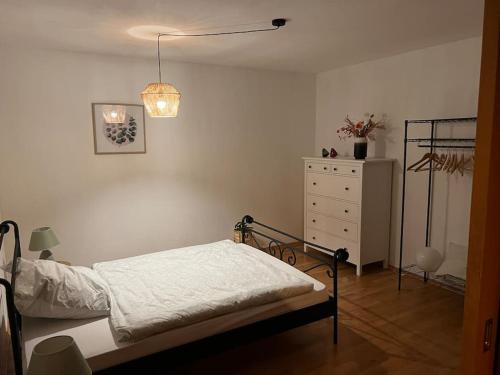 a bedroom with a bed and a dresser in it at Ruhige Wohnung mit Terrasse in Telgte