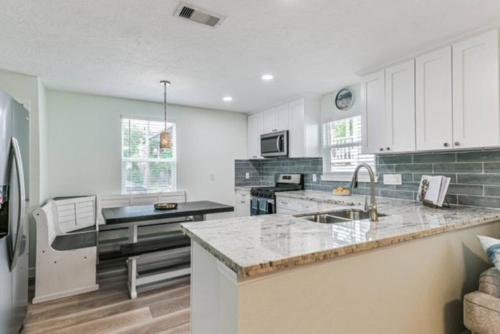 a kitchen with white cabinets and a counter top at Bella's Beach House 2811 Avenue O 1/2 in Galveston