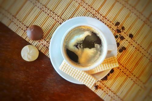 a cup of coffee and cookies on a table at Hostal Casa Grande in Villazón