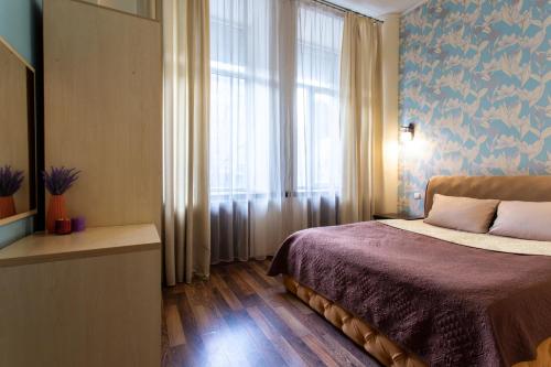 a bedroom with a bed and a large window at Royal Apartment on Pushkinskaya in Kharkiv