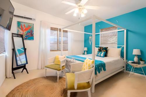 a bedroom with a white bed and a blue wall at Fantastic Island House 1 mile to the beach with heated pool in Sarasota