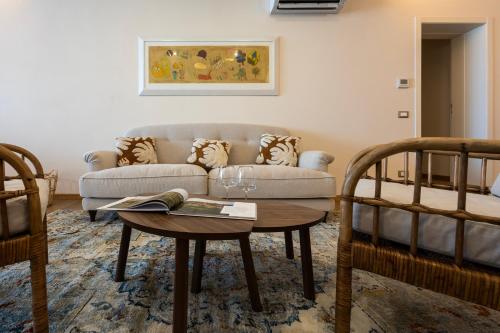 a living room with a couch and a table at Palazzo Gessi Room and Breakfast in Borghi