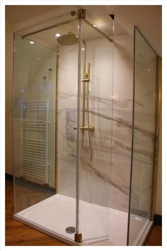 a shower in a glass enclosure in a room at Killeavy Cottage in Meigh