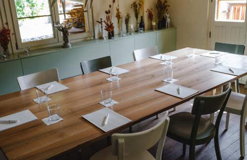 a large wooden table in a room with chairs at CERVO Mountain Resort in Zermatt