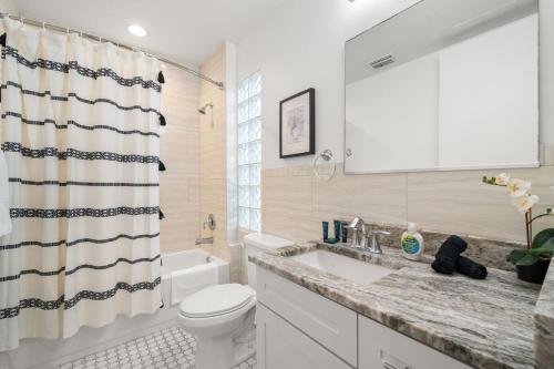 a bathroom with a sink and a toilet and a shower at NEW! Sangria Suite - Upscale Ybor City Studio, Right On 7th Ave in Tampa