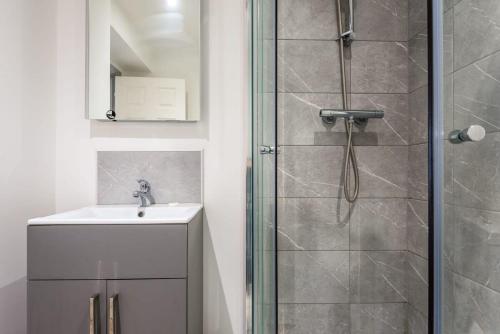 a bathroom with a shower and a sink at Contemporary Budget 1 Bed Apartment in Central Doncaster in Doncaster