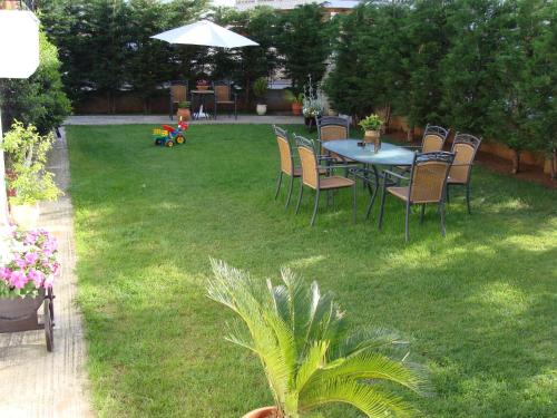 a patio with a table and chairs in a yard at Garden Villa in Ioannina