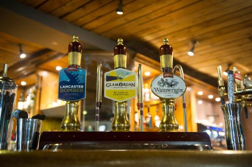 a row of bottles of alcohol on a bar at The Cheshire Cat by Innkeeper's Collection in Chester