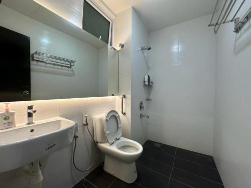 a bathroom with a white toilet and a sink at JB Twin Galaxy Residence Studio City View in Johor Bahru