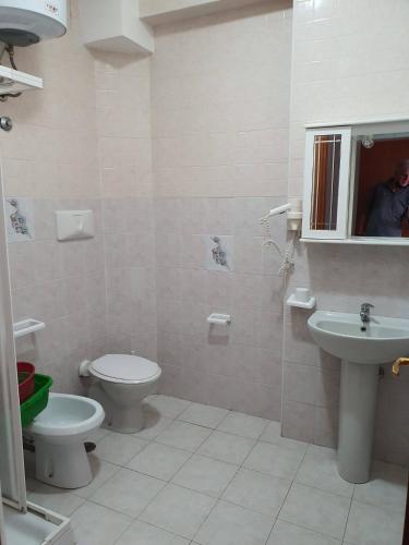a bathroom with a toilet and a sink at Villaggio Hotel Club La Pace in Tropea