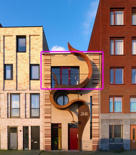 a building with a sculpture on the side of it at Huis met de krul in Amsterdam