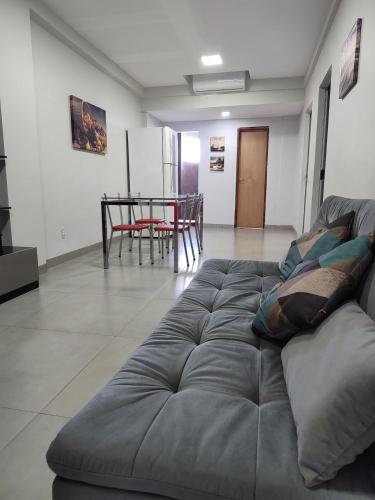 a living room with a couch and a table at Essência in Palmas