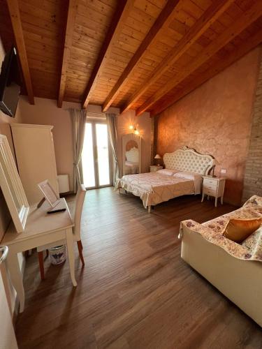 a living room with two beds and a table at Agriturismo le Fontanelle da Valente in Montichiari
