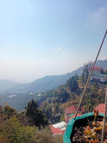 a gondola ride in the mountains with a view at Beechwood Holiday Apartments in Mussoorie