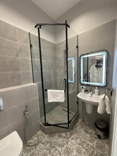 a bathroom with a shower and a sink at Five's Hotel Astana in Astana