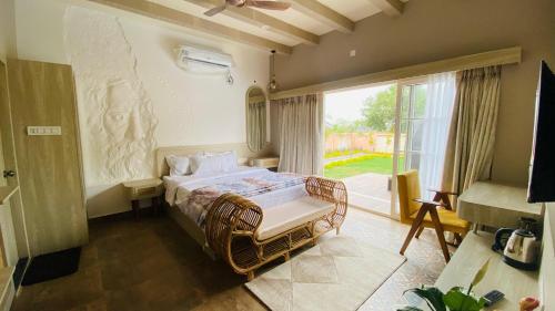 a bedroom with a bed and a large window at Chaitali The Villa in Shānti Niketan