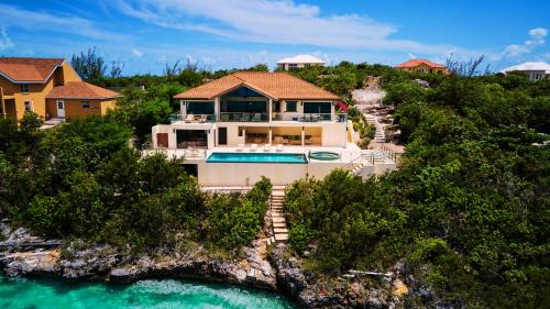 an aerial view of a house with a swimming pool at Alta Bella Villa and Spa in Providenciales