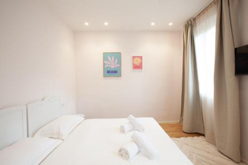 フィレンツェにあるSanta Maria Novella Apartmentの白いベッド(白い枕付)が備わるベッドルームです。