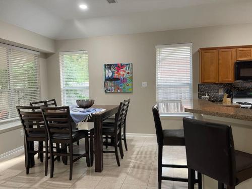 a kitchen and dining room with a table and chairs at Lovely Woodlands home w/heated pool and spa! in Spring