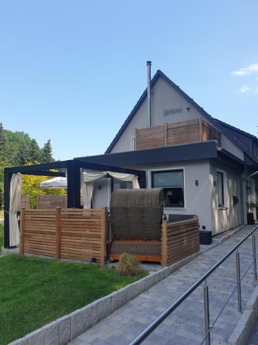 a house with a porch with a couch in front of it at likehome Suite in Buchholz in der Nordheide