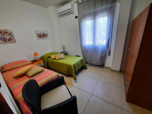 a room with two beds and a window in it at B&B Costa Gentile in Taranto