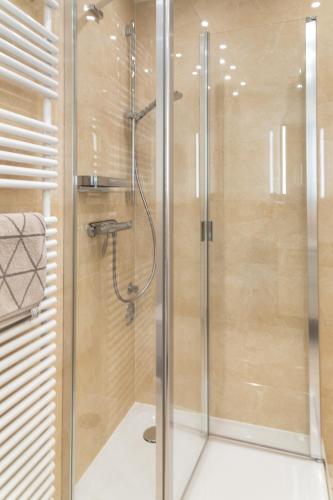 a shower with a glass door in a bathroom at Ferienwohnung Königsmann in Strandnähe in Westerland