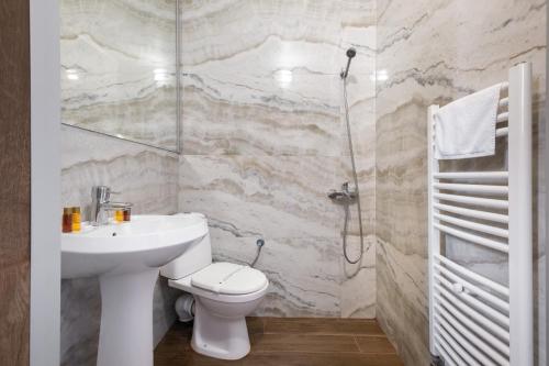 a bathroom with a sink and a toilet and a shower at Katalina SPA Resort in Tsigov Chark