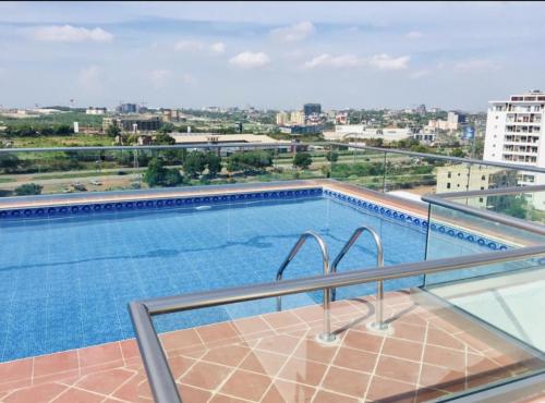 a swimming pool on the roof of a building at The Moonlight Manor Suite in Accra