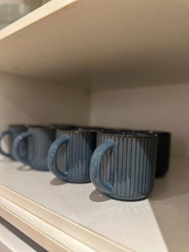 a row of blue cups sitting on top of a stove at Opulent oasis in London in London