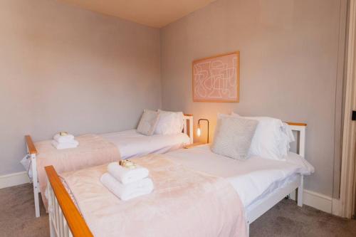 a room with two beds with towels on them at Well located 3 bedroom home in central Chester with Parking in Chester