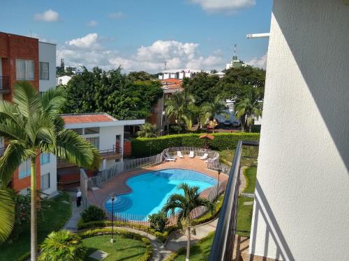 a view of the pool from the balcony of a building at APARTAMENTO VILLA OLÍMPICA in Pereira
