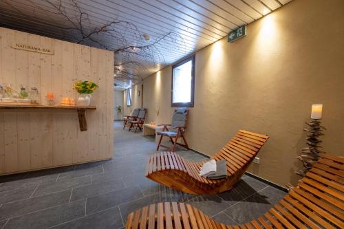 a room with two chairs and a waiting room with a table at Toni's Alpine Loft & SPA in Kandersteg