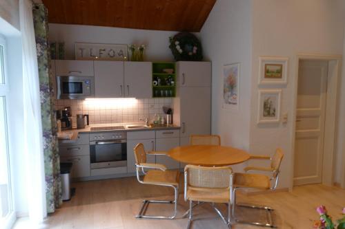 a kitchen with a table and chairs in a room at Ferienhaus 2 in Fritzlar