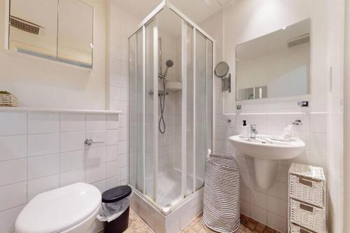 a bathroom with a shower and a toilet and a sink at Stunning studio apt- 5 min walk to Borough station in London