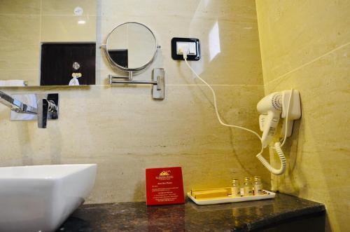 La Shayok Resort في نوبرا: حمام مع حوض وهاتف على الحائط
