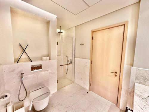 a bathroom with a toilet and a walk in shower at Luxury Studio in High Floor Full Sea View in The Palm Tower Plam Jumeirah in Dubai