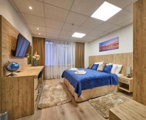a bedroom with a blue bed and a television at Sleep1c in Hamburg