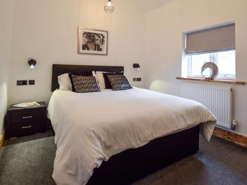 a bedroom with a large bed and a window at 1 Bed in Malton 88457 