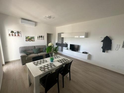 a living room with a table and a couch at Casa Valeria in Taranto