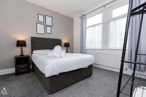 a bedroom with a bed with two pillows on it at Pine House in Stockton-on-Tees
