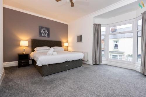 a bedroom with a bed and a large window at Pine House in Stockton-on-Tees