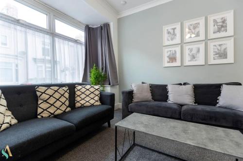 a living room with two couches and a table at Pine House in Stockton-on-Tees