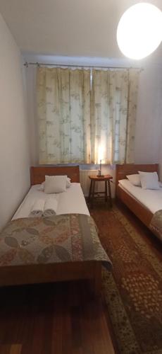 - une chambre avec deux lits et une table avec une lampe dans l'établissement Pokoje Kwaskowa Góra 24, à Kazimierz Dolny