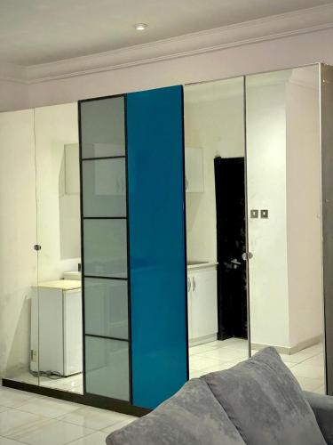 a bedroom with a large blue glass closet at Executive suite escape in Lekki